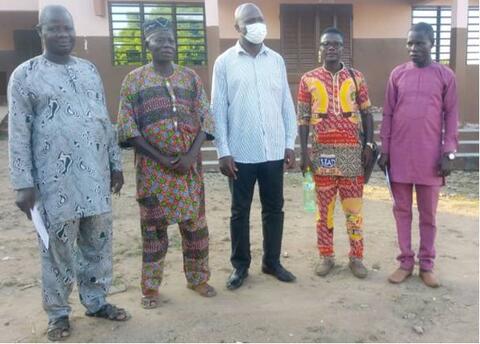 Group photo of two members of the Board of Directors, the team and the District Chief of Challa-Ogoi
