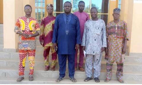 Group photo of the members of the Board of Directors and the team with the mayor of Ouèssè.